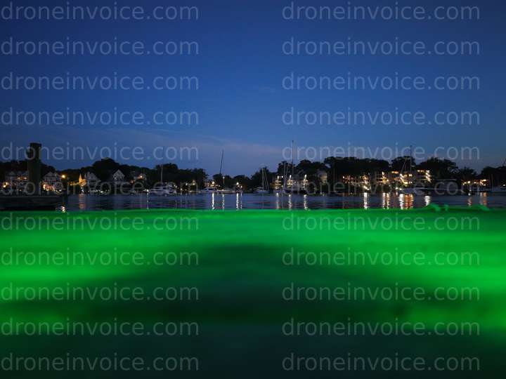 Cover for Boats at night with green ambient light from drone