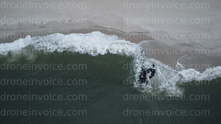 Cover for Ocean Surf breaking on beach with small breakwater